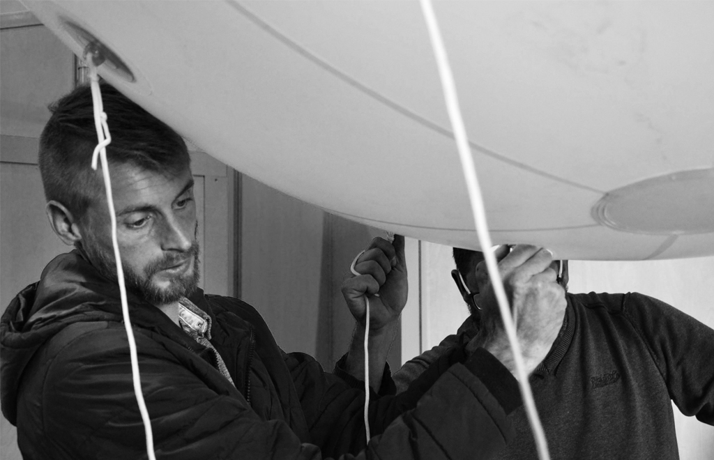 Benoit and Xavier install a balloon on a customer's stand at the Space show